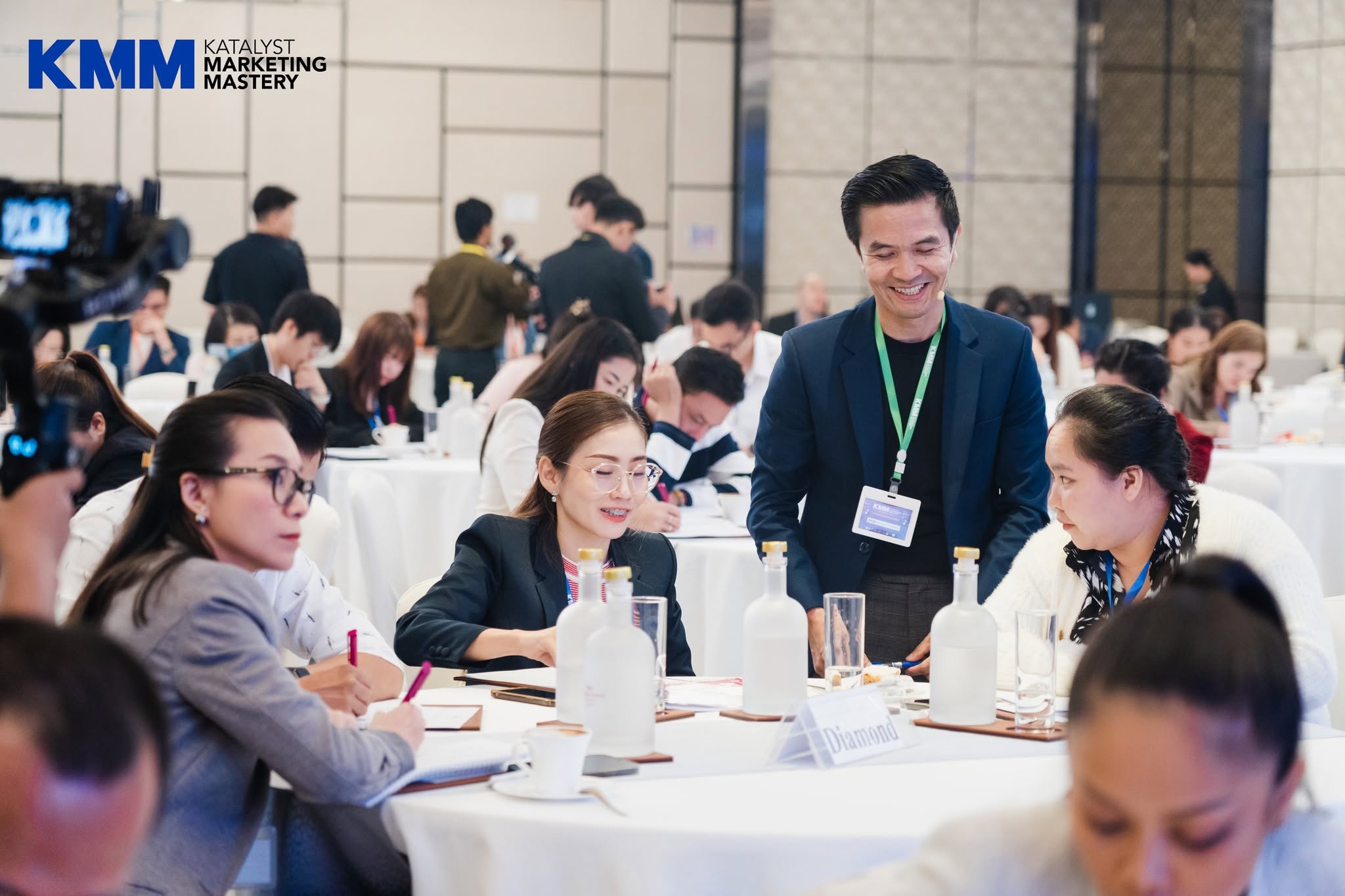 A facilitator supporting participants during a Katalyst Marketing Mastery exercise
