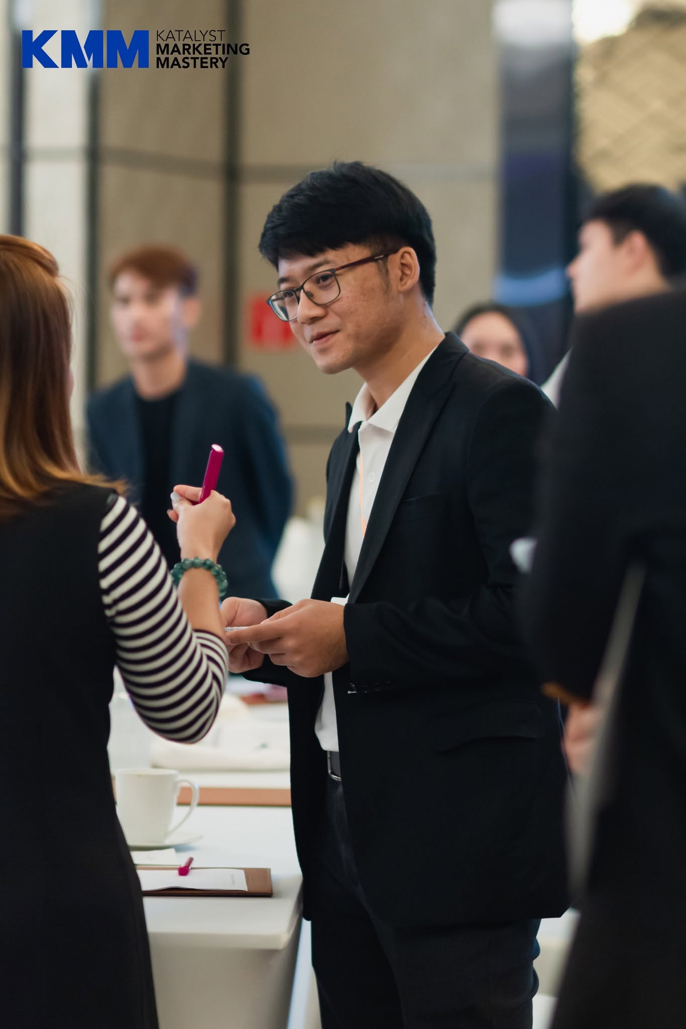 A participant exchanging ideas during Katalyst Marketing Mastery