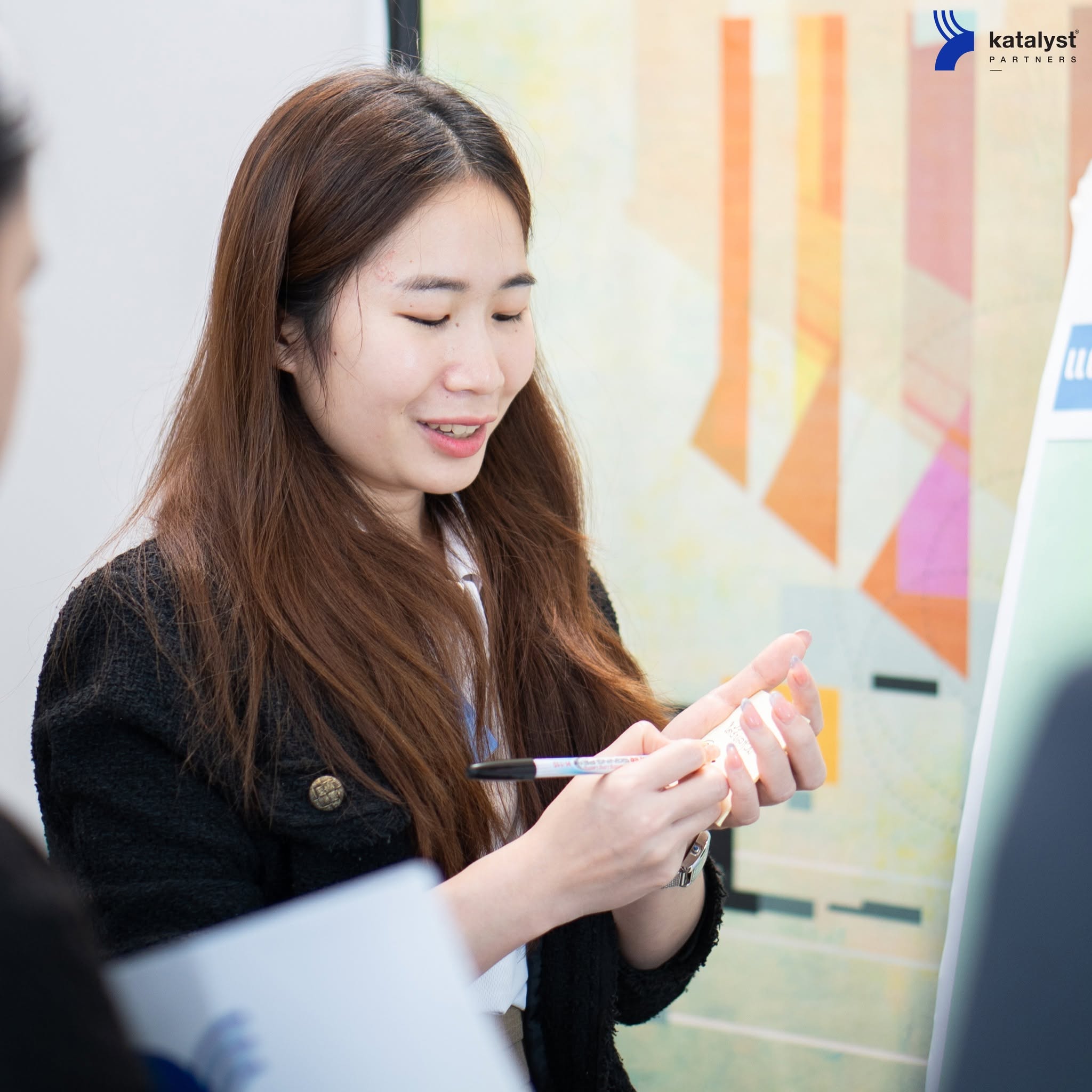 A manager working through a practical exercise in a Katalyst workshop