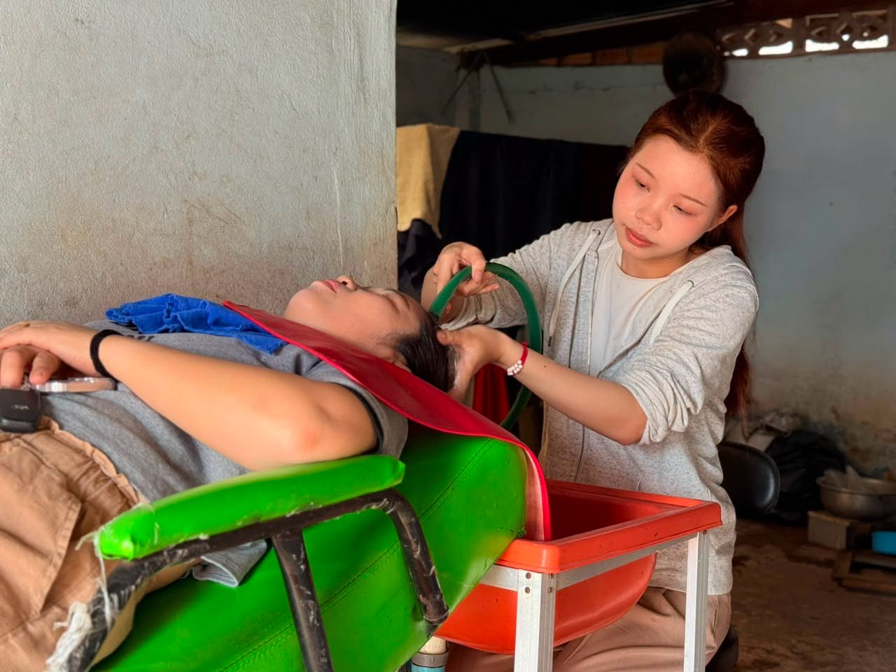 A young woman operating a hair salon