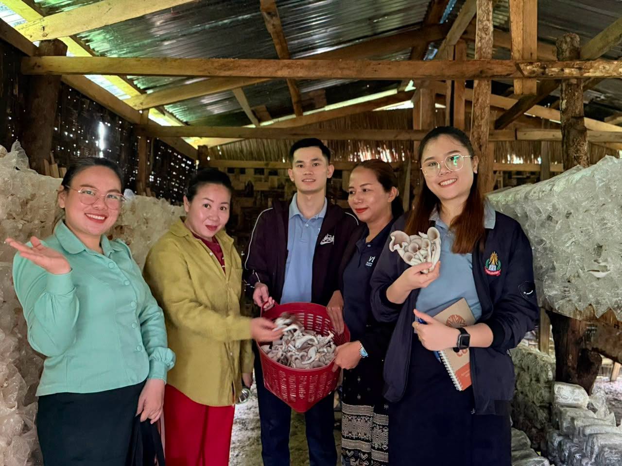 Young entrepreneurs and coaches visiting a mushroom business