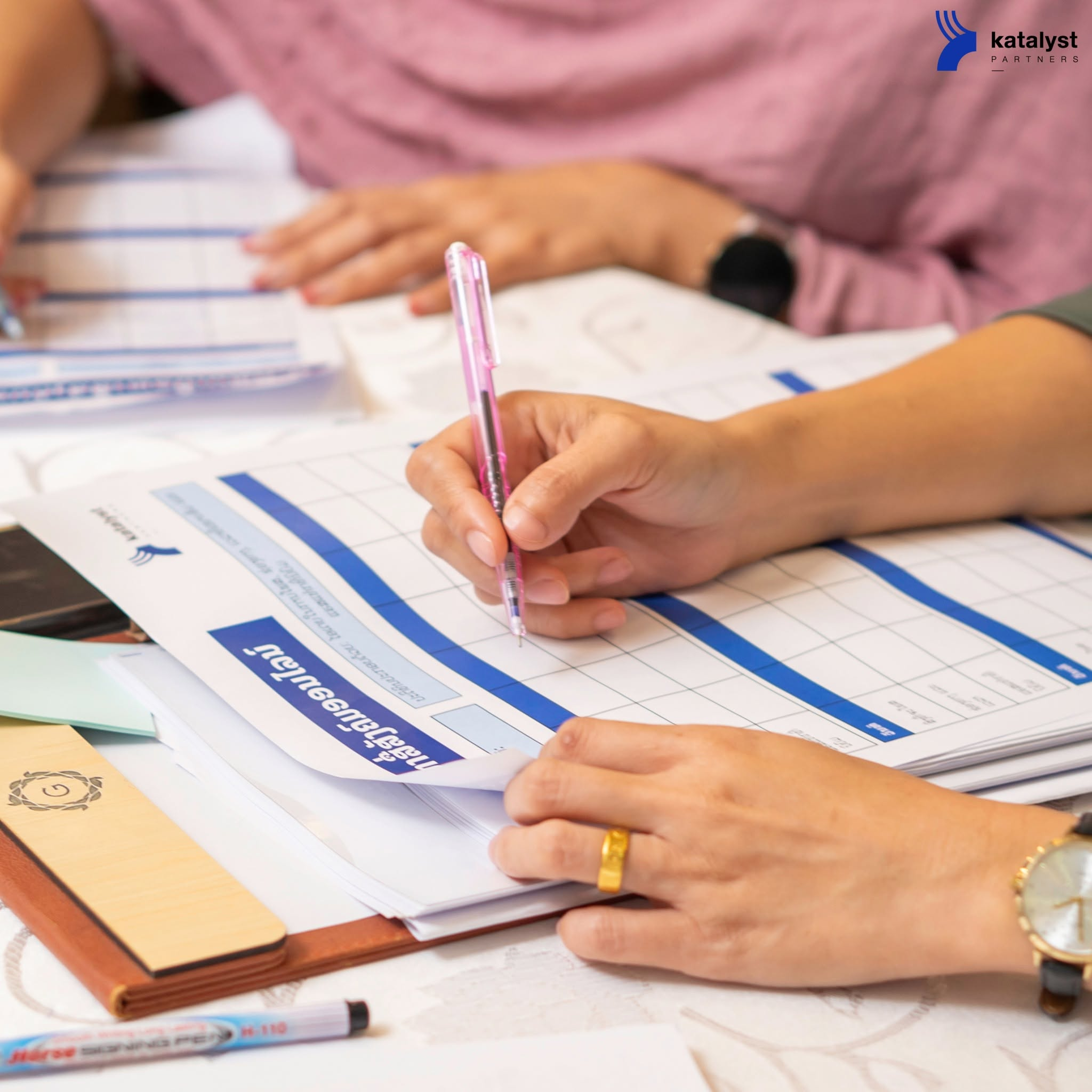 A B-Strong participant completing a practical business worksheet