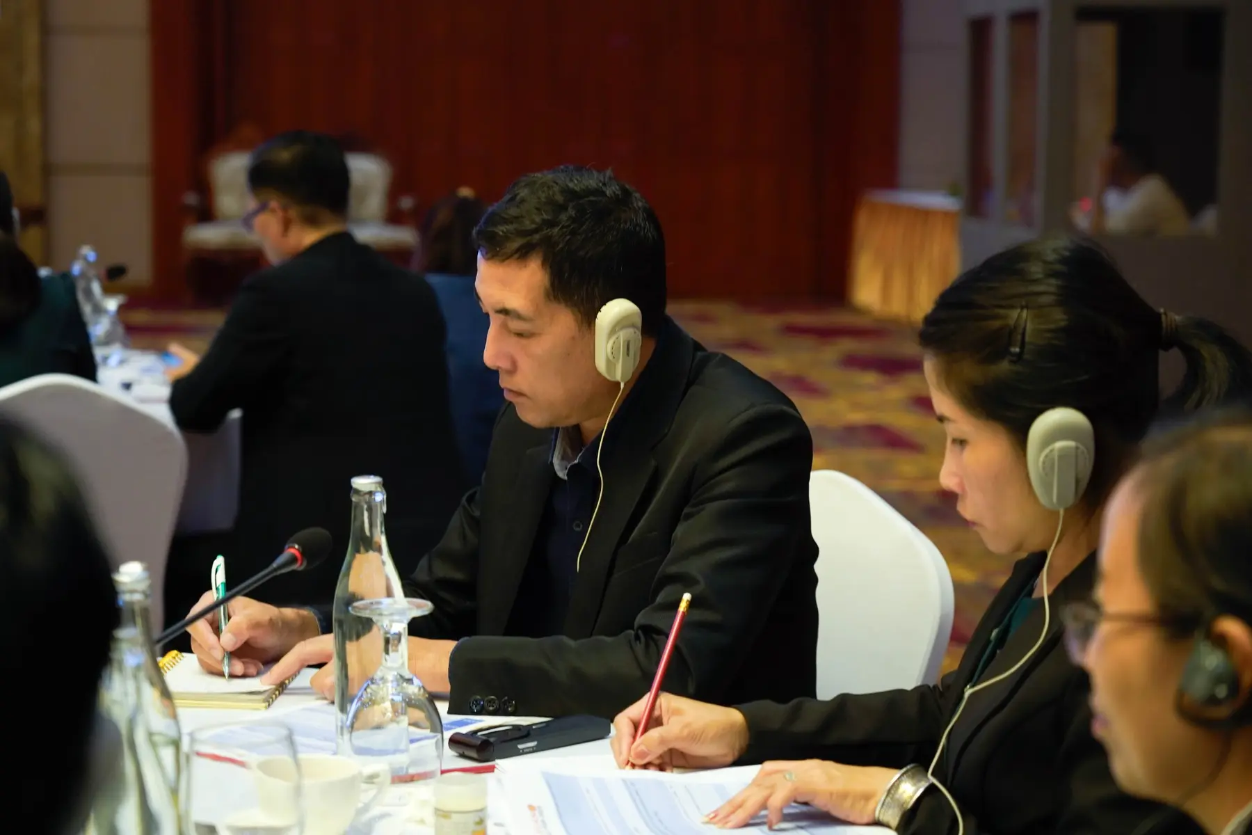 Participants using interpretation headsets during the media workshop