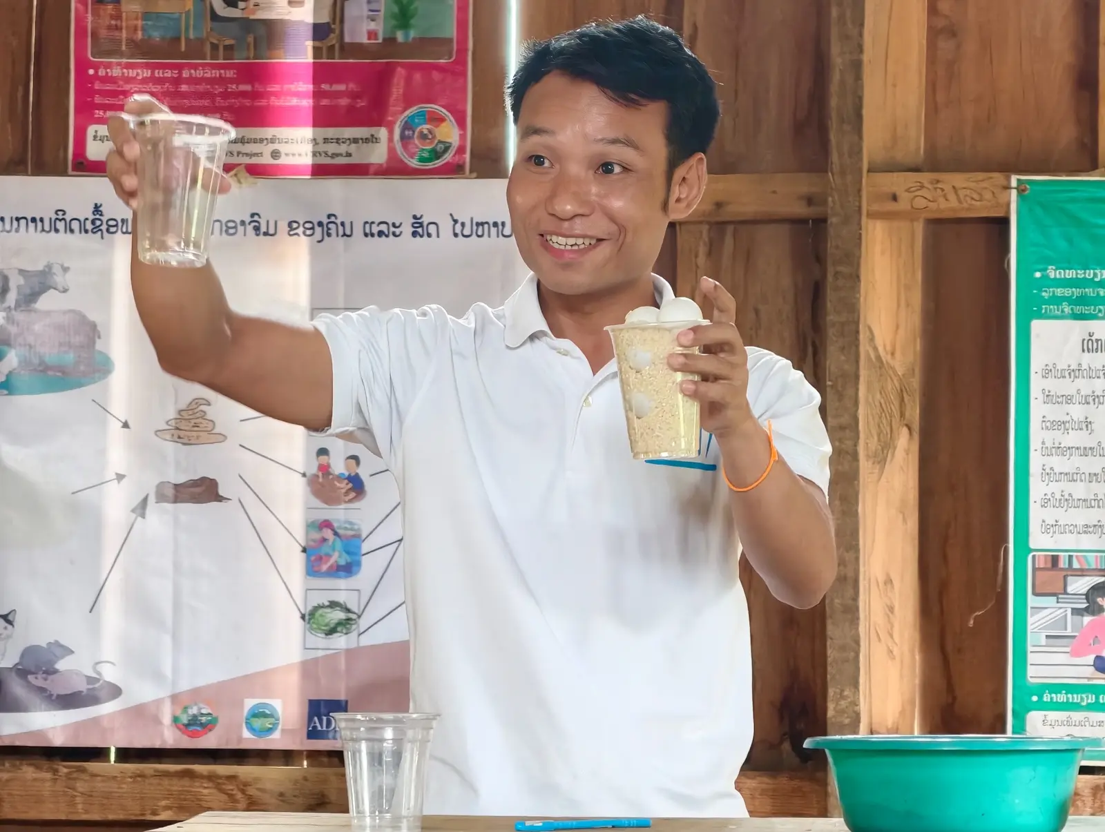 A trainer demonstrating nutrition concepts with locally available materials