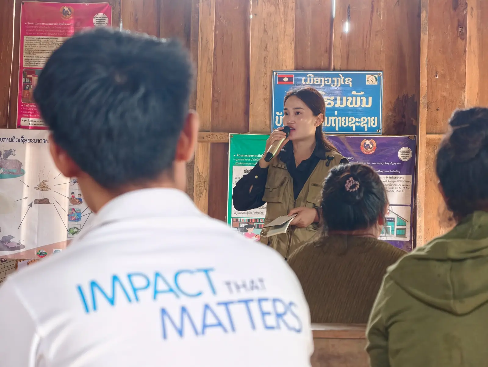 A field facilitator speaking with community participants