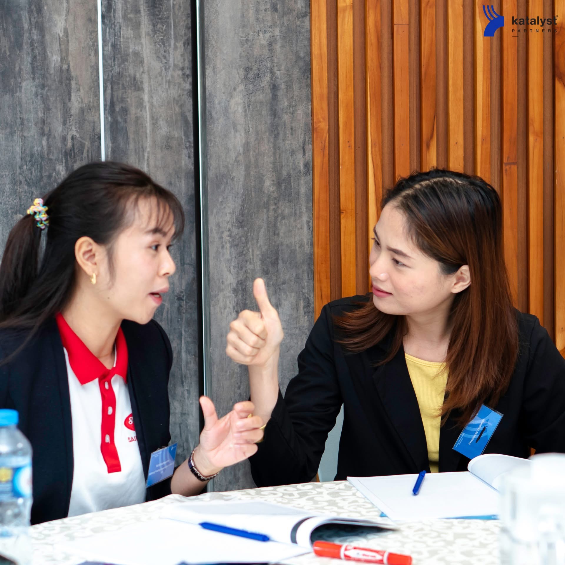 Two participants discussing a workplace people-management issue