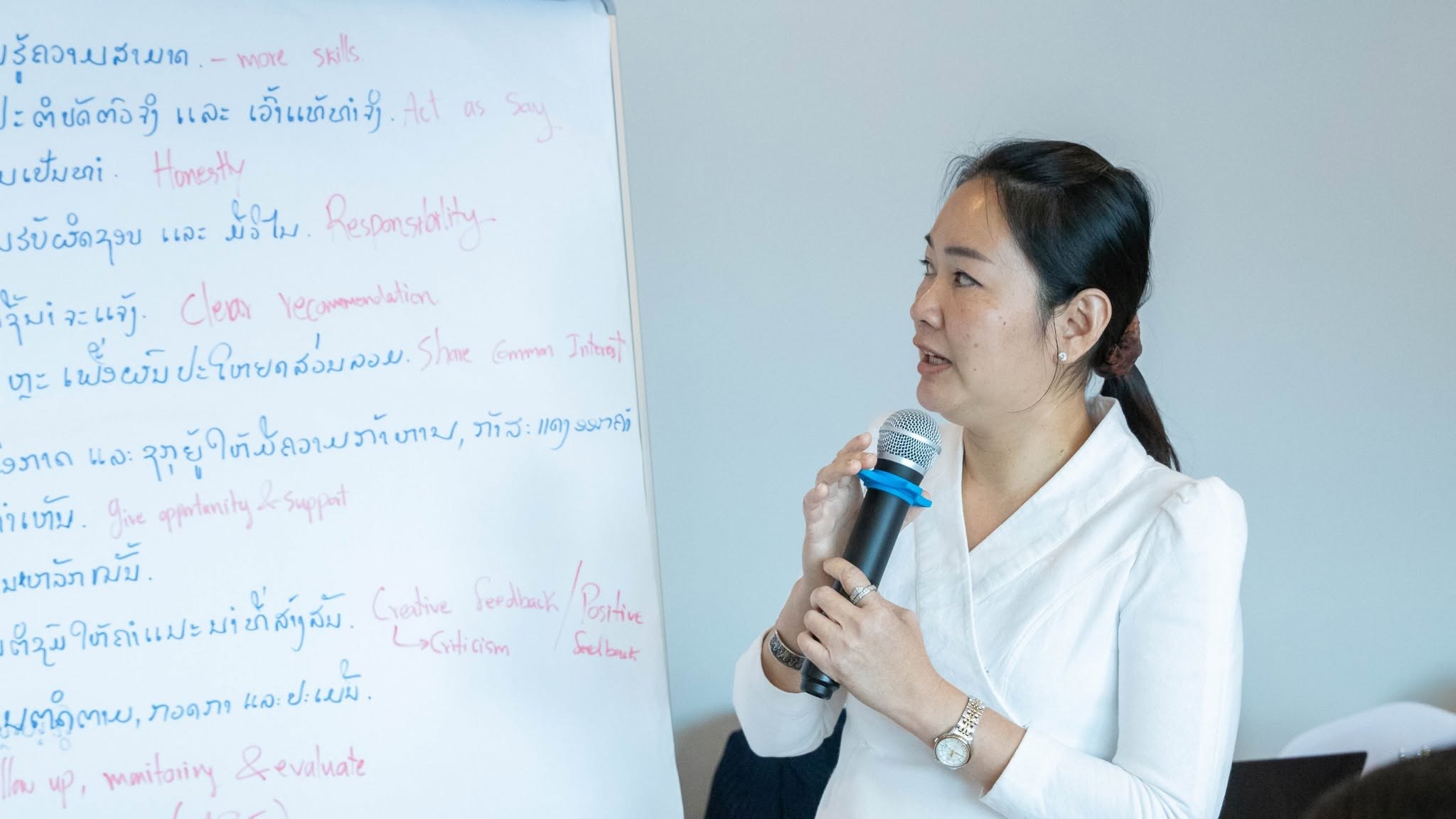 A participant presenting leadership ideas in Lao and English