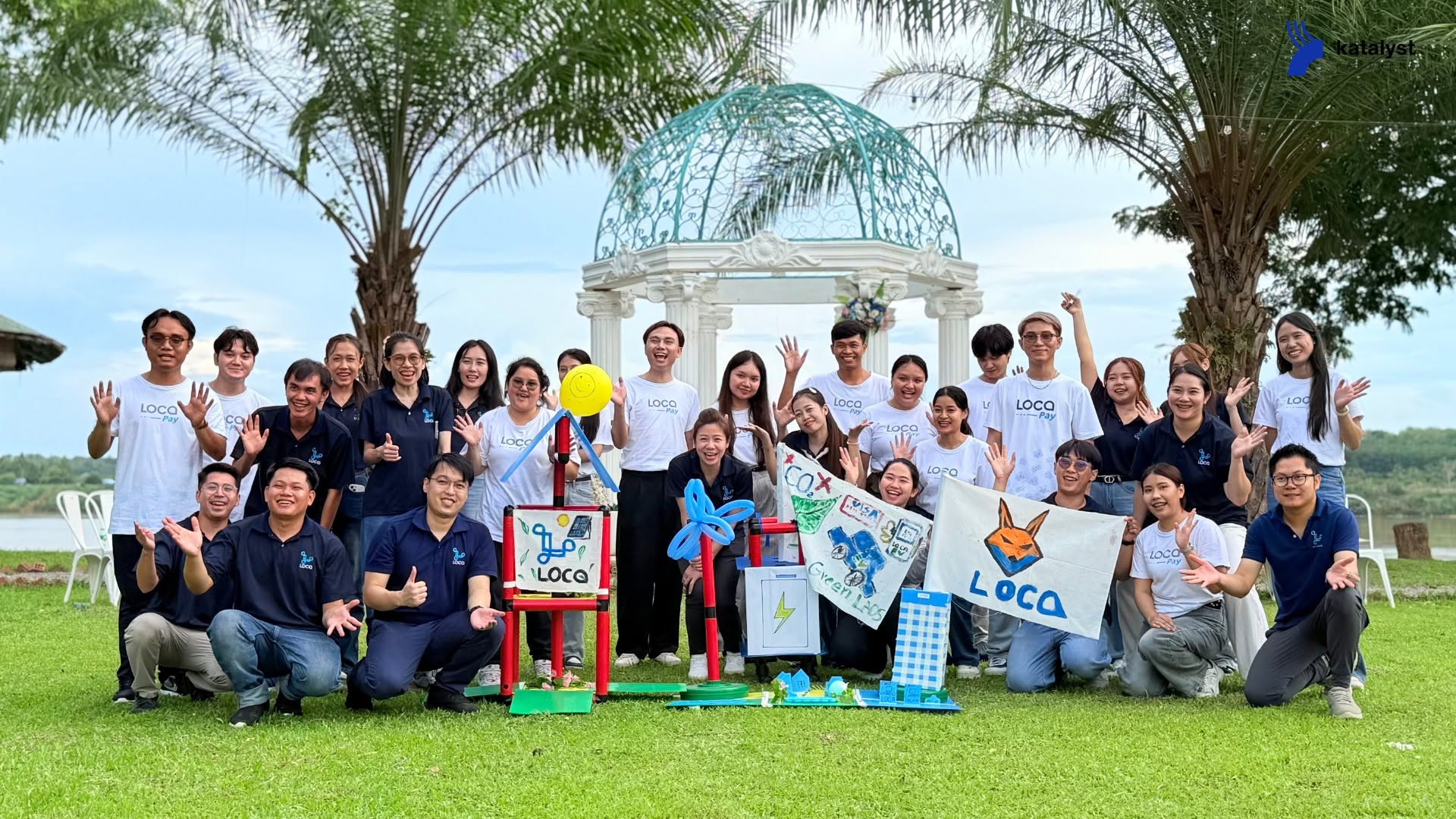 The LOCA team with the models, flags, and artwork they created together