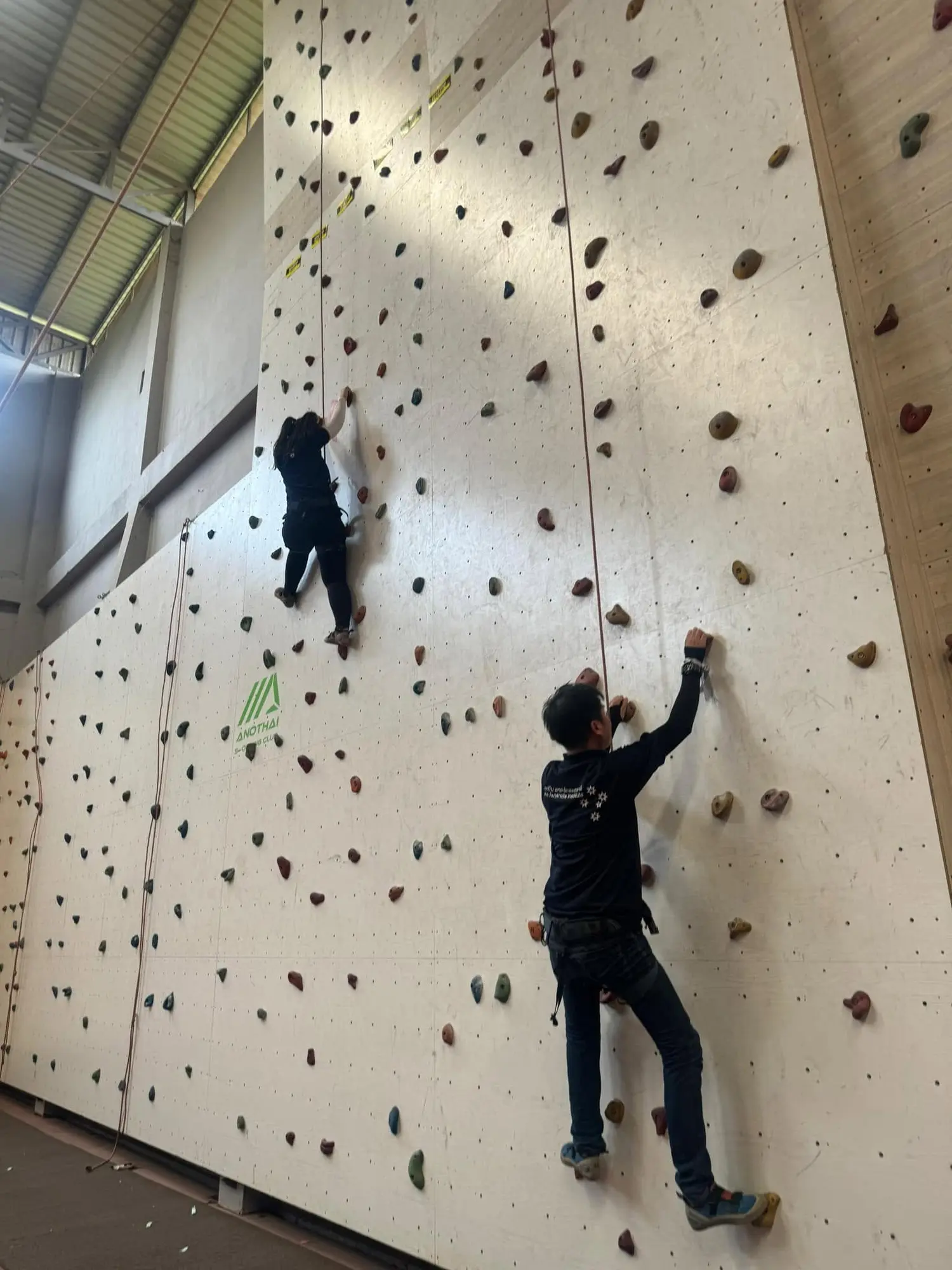 Participants tackling a climbing-wall challenge