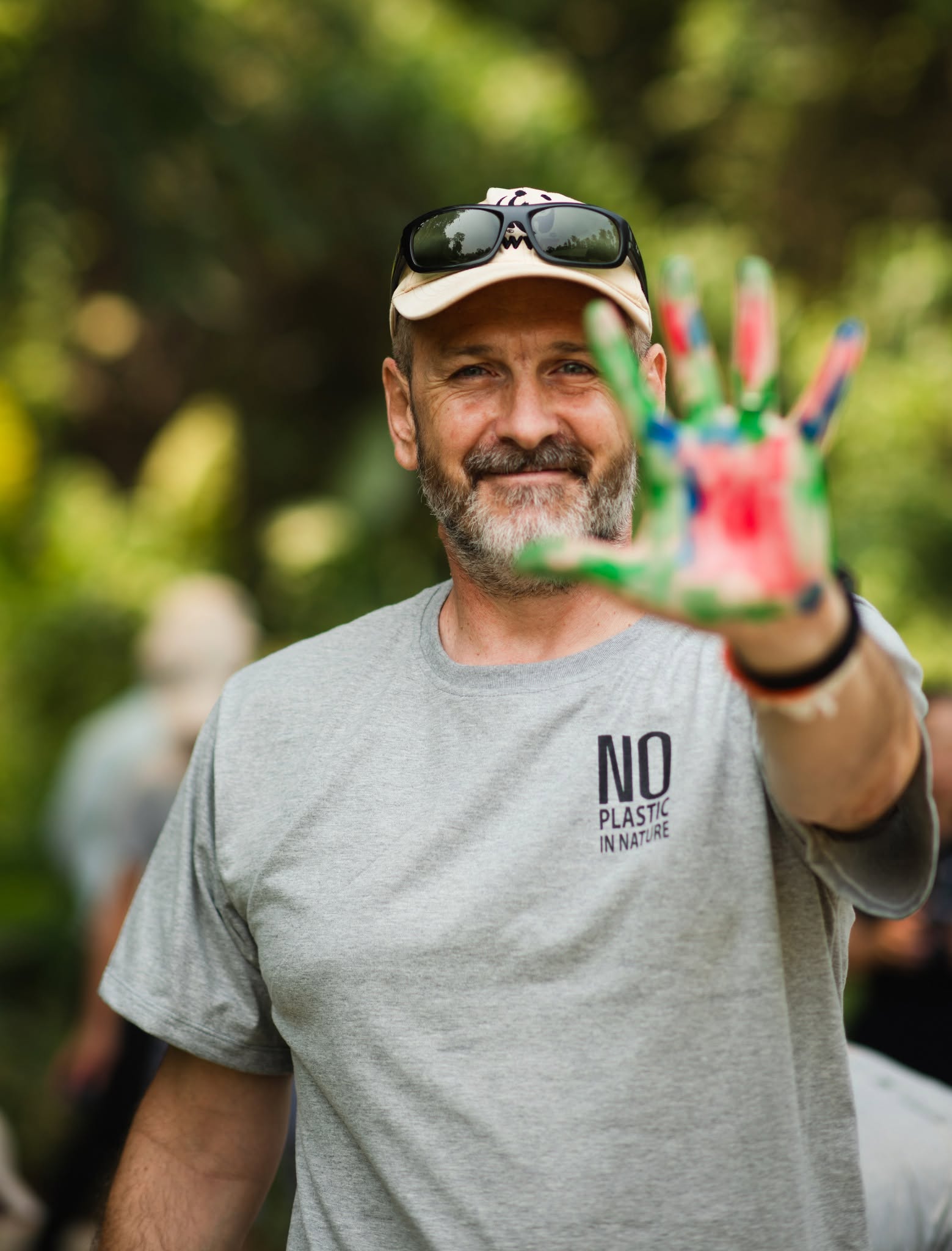 A smiling WWF participant sharing a colorful painted hand