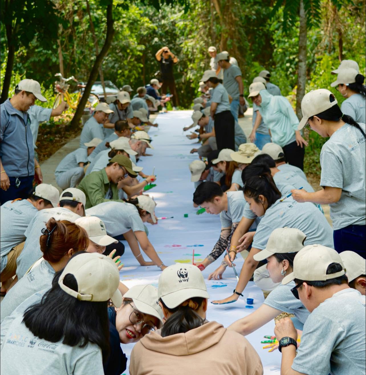 WWF colleagues creating a large shared painting together outdoors